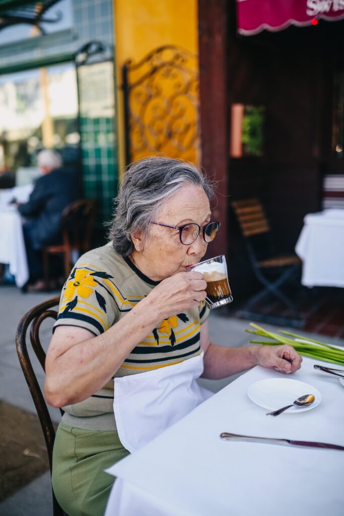 a senior woman having coffee outside
