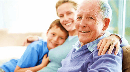A Family Smiling At The Camera