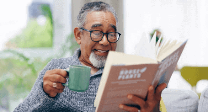 A man reading a book with a coffee